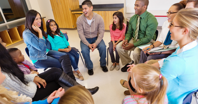 Parents sit together with children in a Sunday school circle